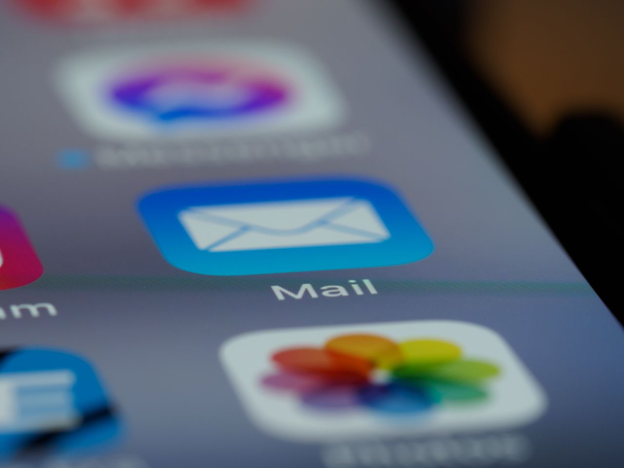services-02 Detailed close-up of an email app icon on a smartphone screen, showcasing modern technology.